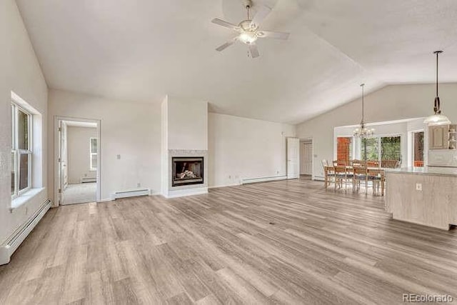 14694 Crooked Trail Rd, Woodland Park, CO 80863 - unfurnished living room featuring a baseboard heating unit, a ceiling fan, light wood-type flooring, baseboard heating, and high vaulted ceiling