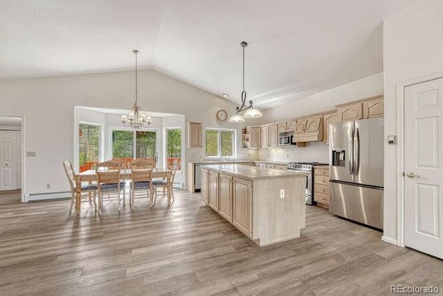 14694 Crooked Trail Rd, Woodland Park, CO 80863 - kitchen with appliances with stainless steel finishes, light brown cabinets, vaulted ceiling, light wood-type flooring, and light countertops