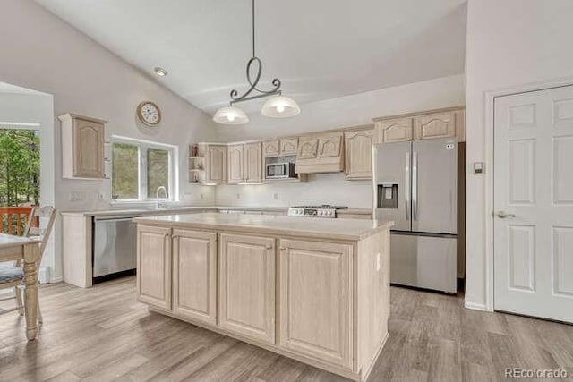 14694 Crooked Trail Rd, Woodland Park, CO 80863 - kitchen featuring stainless steel appliances, light brown cabinetry, light countertops, a kitchen island, and light wood-type flooring