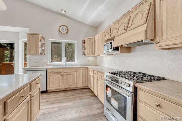 14694 Crooked Trail Rd, Woodland Park, CO 80863 - kitchen featuring stainless steel appliances, light brown cabinetry, open shelves, light countertops, and lofted ceiling