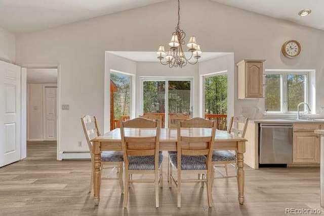 14694 Crooked Trail Rd, Woodland Park, CO 80863 - dining area with light wood-style floors, a chandelier, vaulted ceiling, and a baseboard radiator