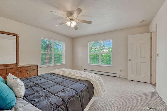 14694 Crooked Trail Rd, Woodland Park, CO 80863 - carpeted bedroom with a baseboard heating unit, ceiling fan, and baseboards
