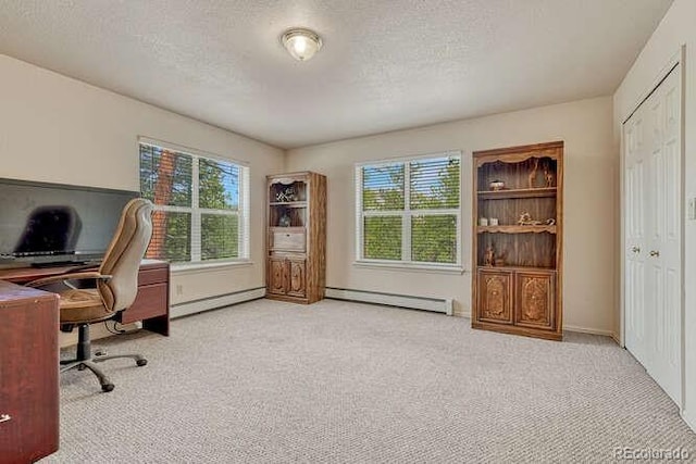 14694 Crooked Trail Rd, Woodland Park, CO 80863 - home office featuring a baseboard heating unit, light colored carpet, baseboard heating, a textured ceiling, and baseboards