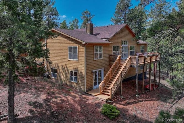 14694 Crooked Trail Rd, Woodland Park, CO 80863 - rear view of property featuring stairs, a chimney, and a wooden deck