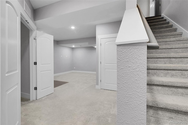 finished basement with recessed lighting, baseboards, carpet flooring, visible vents, and stairway
