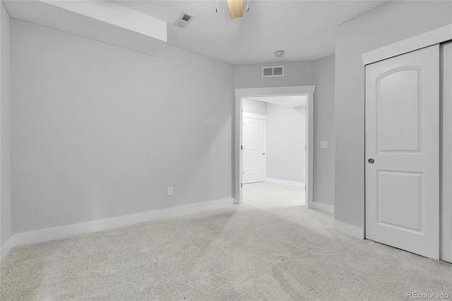 unfurnished bedroom with visible vents, baseboards, and light carpet