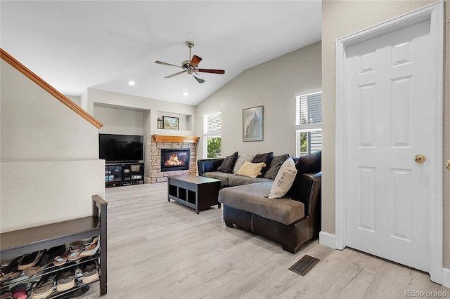 12585 S Beaver Creek Way, Parker, CO 80134 - living room with ceiling fan, a stone fireplace, vaulted ceiling, light wood-style floors, and recessed lighting