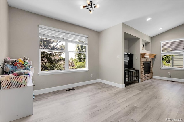 12585 S Beaver Creek Way, Parker, CO 80134 - living room with light wood-type flooring, a chandelier, recessed lighting, a fireplace, and lofted ceiling