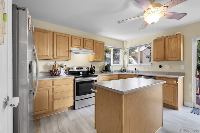12585 S Beaver Creek Way, Parker, CO 80134 - kitchen featuring stainless steel appliances, under cabinet range hood, light wood-style floors, light countertops, and a center island