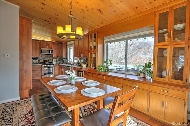 dining space featuring an inviting chandelier and wooden ceiling