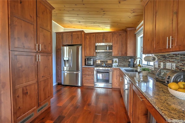 kitchen with decorative backsplash, brown cabinets, stainless steel appliances, and a sink