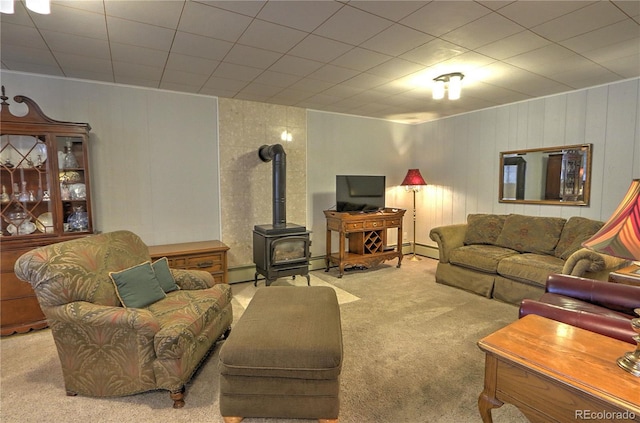 carpeted living area featuring a wood stove