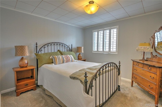 bedroom featuring baseboards and light colored carpet