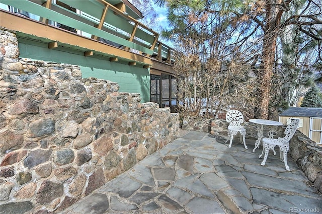 view of patio with an outbuilding