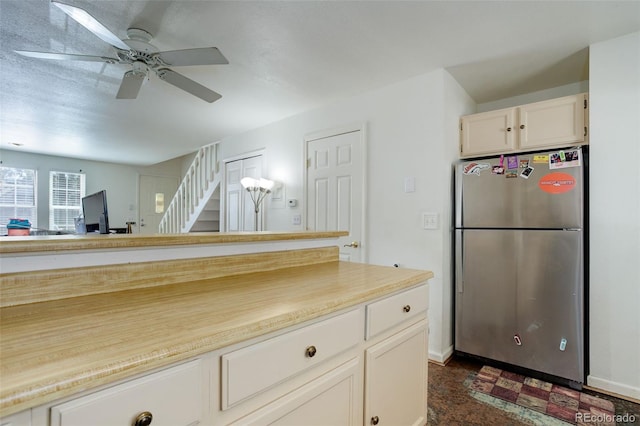 kitchen with ceiling fan and stainless steel refrigerator