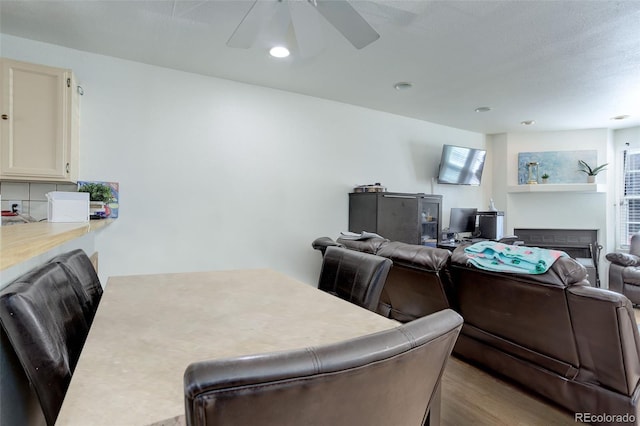 dining area with ceiling fan and light wood-type flooring