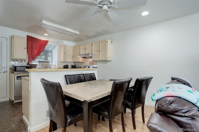 dining area with ceiling fan and light wood-type flooring