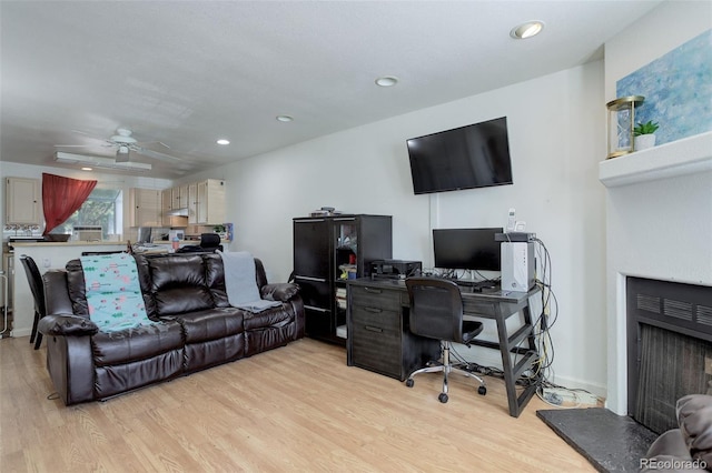 office with ceiling fan and light wood-type flooring