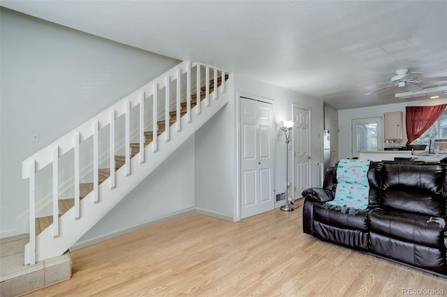 living room featuring ceiling fan and light wood-type flooring