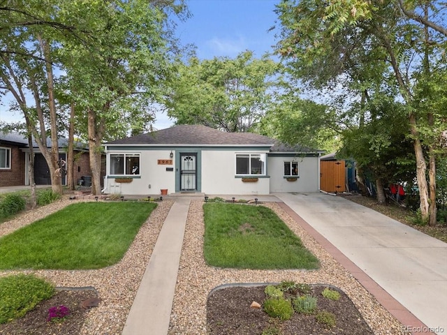 2967 Olive St, Denver, CO 80207 - ranch-style house featuring driveway, stucco siding, a front yard, and a shingled roof