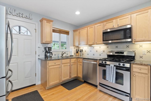 2967 Olive St, Denver, CO 80207 - kitchen with appliances with stainless steel finishes, light brown cabinets, a sink, dark stone countertops, and recessed lighting