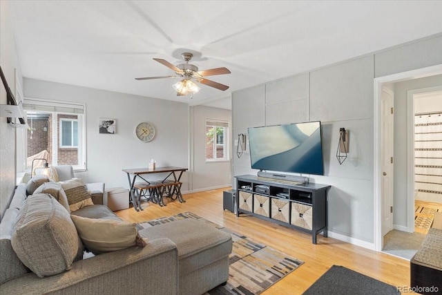 2967 Olive St, Denver, CO 80207 - living area featuring light wood finished floors, a ceiling fan, and baseboards
