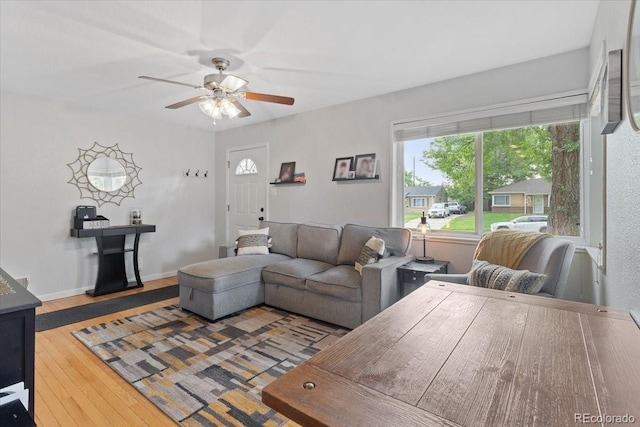 2967 Olive St, Denver, CO 80207 - living area with ceiling fan, healthy amount of natural light, wood finished floors, and baseboards