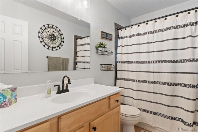 2967 Olive St, Denver, CO 80207 - bathroom with toilet, vanity, a textured wall, and a shower with shower curtain