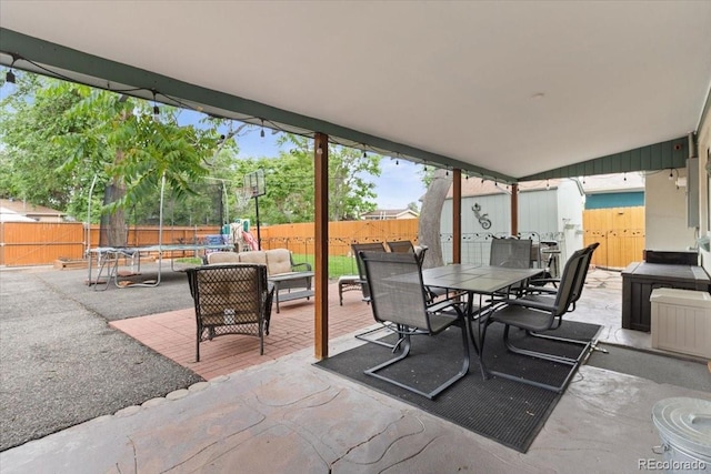 2967 Olive St, Denver, CO 80207 - fenced backyard with a trampoline, a patio, and outdoor dining area