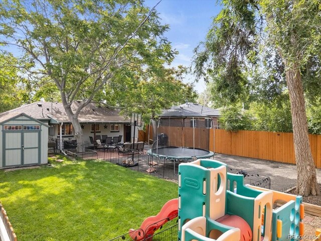2967 Olive St, Denver, CO 80207 - view of yard with a trampoline, a patio area, and a playground