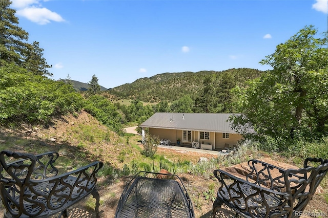 20854 State Highway 96, Wetmore, CO 81253 - back of property with a patio area, a mountain view, a metal roof, and a view of trees