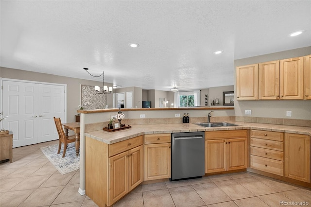 20854 State Highway 96, Wetmore, CO 81253 - kitchen with stainless steel dishwasher, a peninsula, light brown cabinets, tile countertops, and light tile patterned flooring