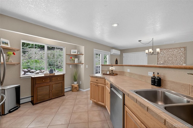 20854 State Highway 96, Wetmore, CO 81253 - kitchen featuring stainless steel dishwasher, an AC wall unit, a textured ceiling, a baseboard heating unit, and a chandelier