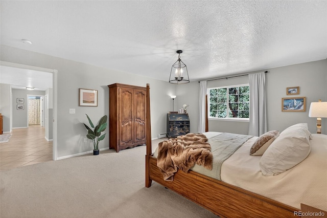 20854 State Highway 96, Wetmore, CO 81253 - bedroom with light colored carpet, a textured ceiling, and light tile patterned floors