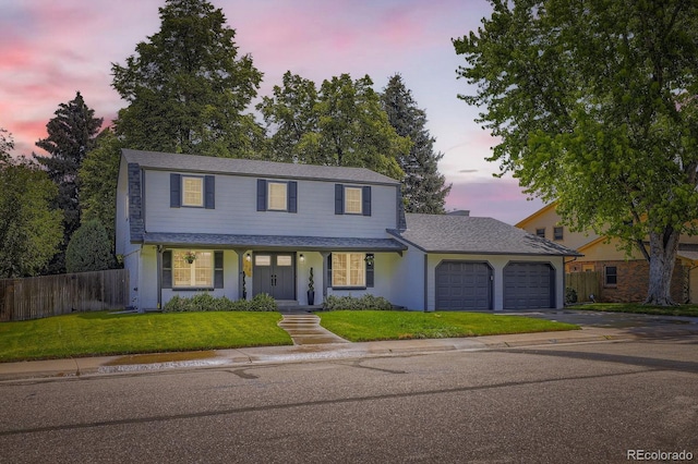 3374 S Niagara Way, Denver, CO 80224 - traditional-style home featuring an attached garage, driveway, covered porch, and a shingled roof