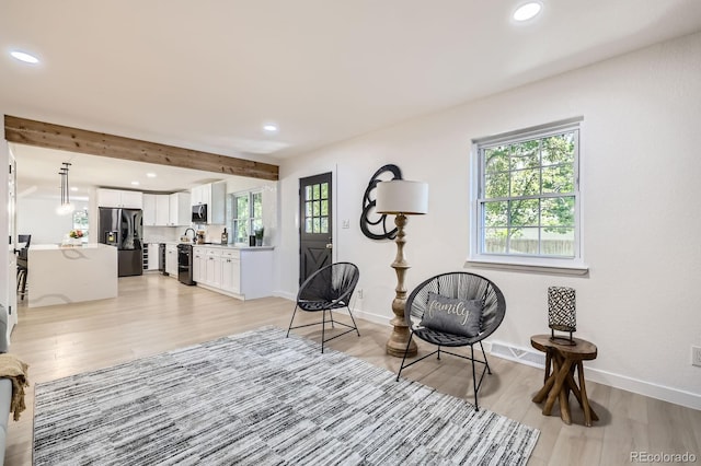 3374 S Niagara Way, Denver, CO 80224 - sitting room featuring light wood-type flooring, recessed lighting, and beamed ceiling