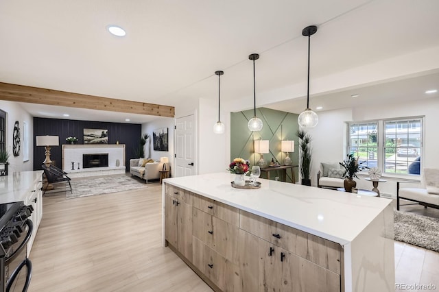 3374 S Niagara Way, Denver, CO 80224 - kitchen featuring open floor plan, light brown cabinets, range with gas stovetop, an accent wall, and recessed lighting