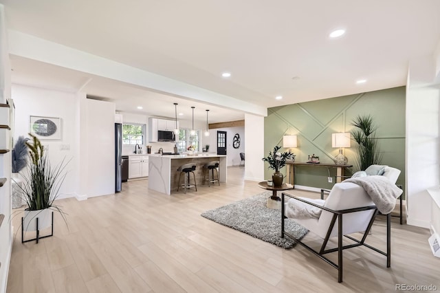 3374 S Niagara Way, Denver, CO 80224 - living area with light wood finished floors and recessed lighting