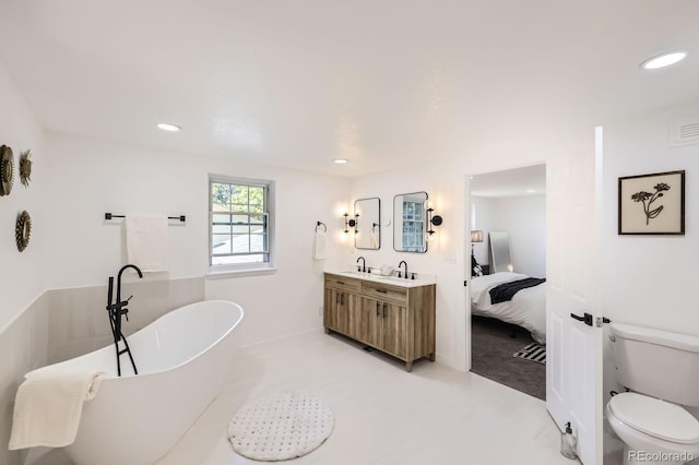 3374 S Niagara Way, Denver, CO 80224 - bathroom with a freestanding bath, double vanity, connected bathroom, and recessed lighting