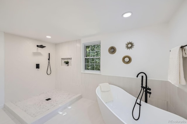 3374 S Niagara Way, Denver, CO 80224 - full bathroom featuring a freestanding bath, a tile shower, wainscoting, and tile walls