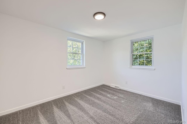 3374 S Niagara Way, Denver, CO 80224 - spare room featuring baseboards and dark colored carpet