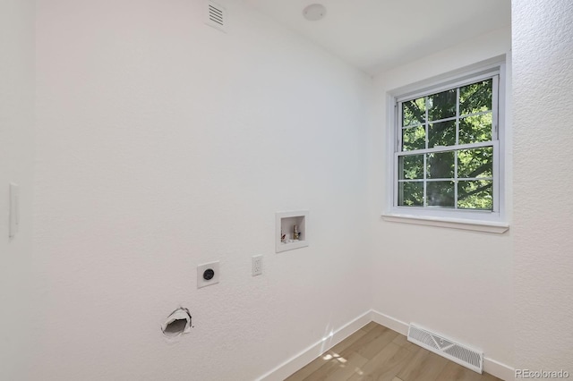 3374 S Niagara Way, Denver, CO 80224 - washroom with hookup for an electric dryer, washer hookup, and light wood finished floors