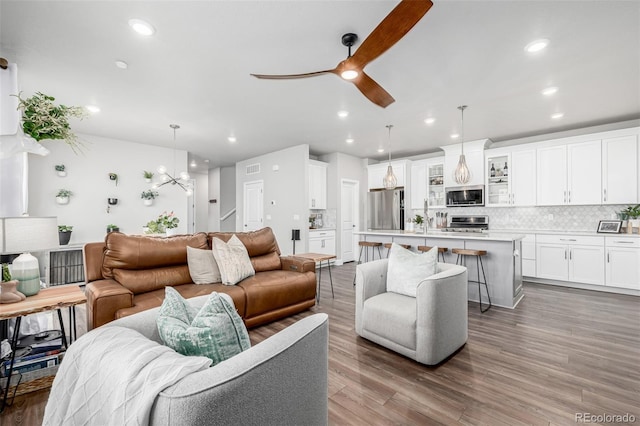 8358 Howell St Unit B, Arvada, CO 80005 - living area with recessed lighting, ceiling fan, wood finished floors, and a chandelier