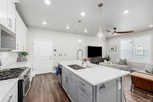8358 Howell St Unit B, Arvada, CO 80005 - kitchen with appliances with stainless steel finishes, gray cabinetry, open floor plan, dark wood finished floors, and ceiling fan