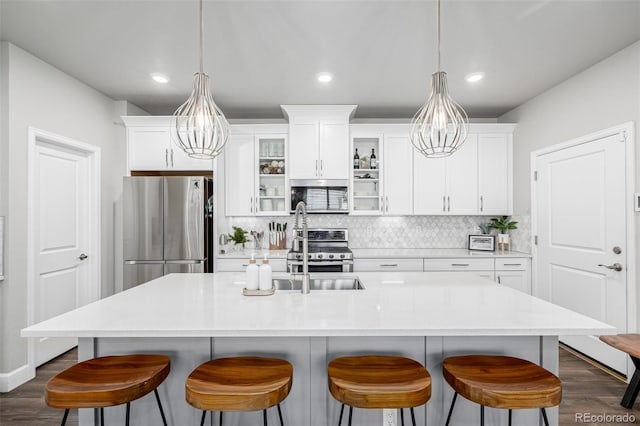 8358 Howell St Unit B, Arvada, CO 80005 - kitchen with appliances with stainless steel finishes, dark wood-style floors, tasteful backsplash, white cabinets, and recessed lighting