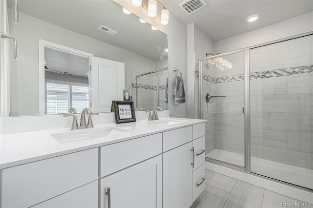 8358 Howell St Unit B, Arvada, CO 80005 - bathroom with double vanity, a shower stall, and recessed lighting