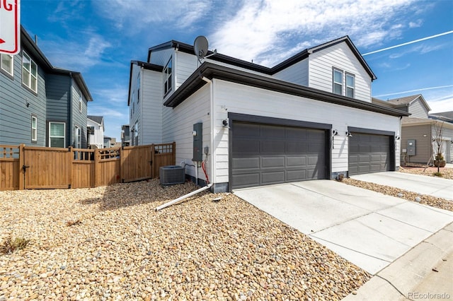 8358 Howell St Unit B, Arvada, CO 80005 - view of property exterior featuring a gate, concrete driveway, and a garage