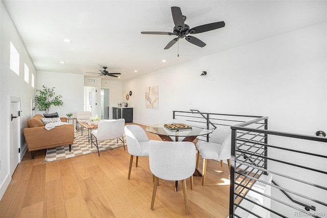 dining room with light hardwood / wood-style flooring and ceiling fan