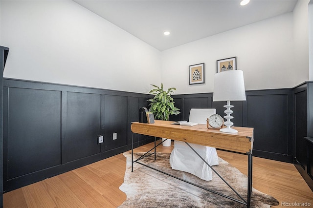 home office with light hardwood / wood-style flooring