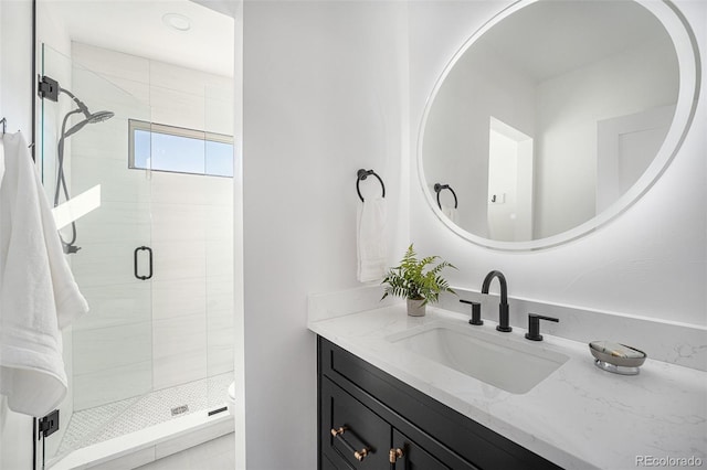 bathroom with vanity and a shower with shower door